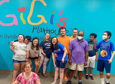 Group of smiling adults with Down syndrome at GiGi's Playhouse Annapolis