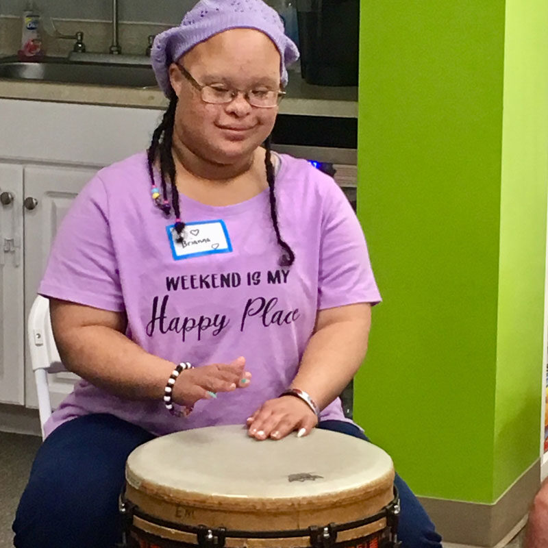 GiGi's Playhouse Annapolis, Girl with Down Syndrome playing drums