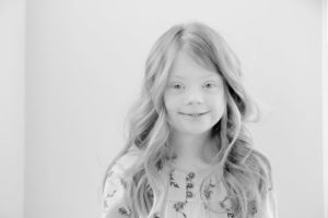 Black and white photo of a young girl with Down syndrome