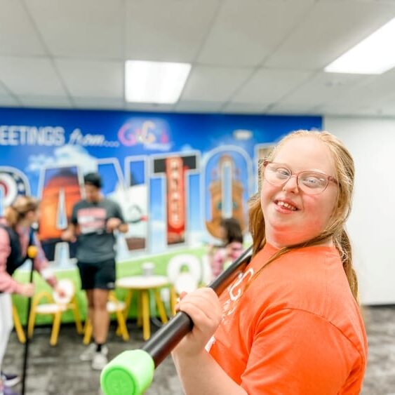 girl with Down syndrome using a weighted bar for exercise