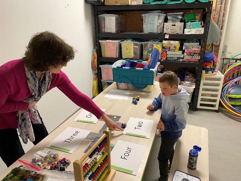 Ian and Sue, his math tutor, working on the numbers 1 - 4.