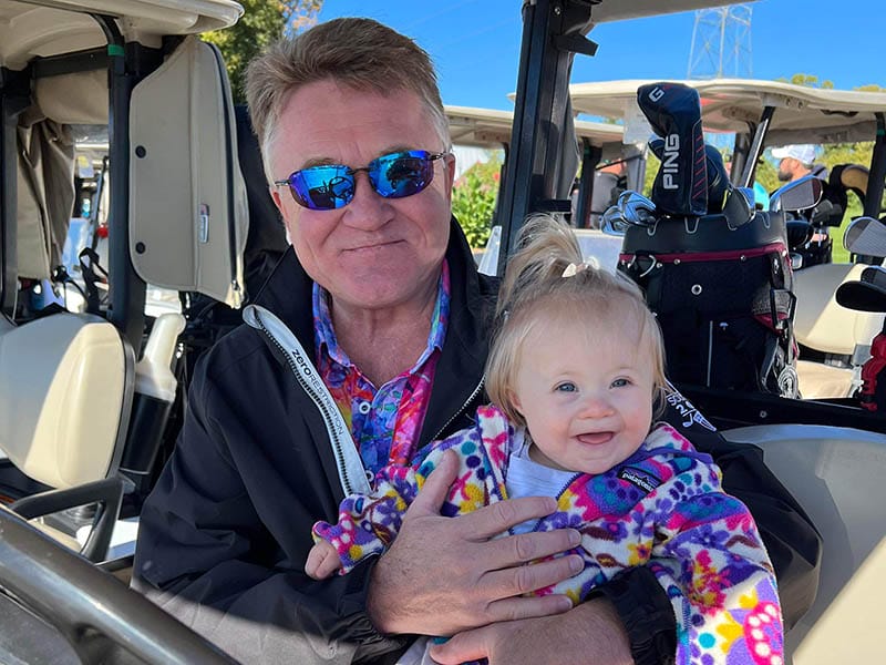 Lucia sitting in a golf cart