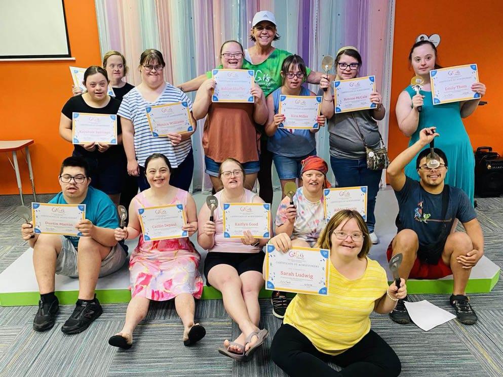 Group of teens with Down syndrome showing their GiGi's Kitchen certificates