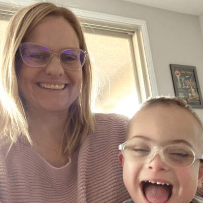 Proud smiling mom with her smiling son with Down syndrome