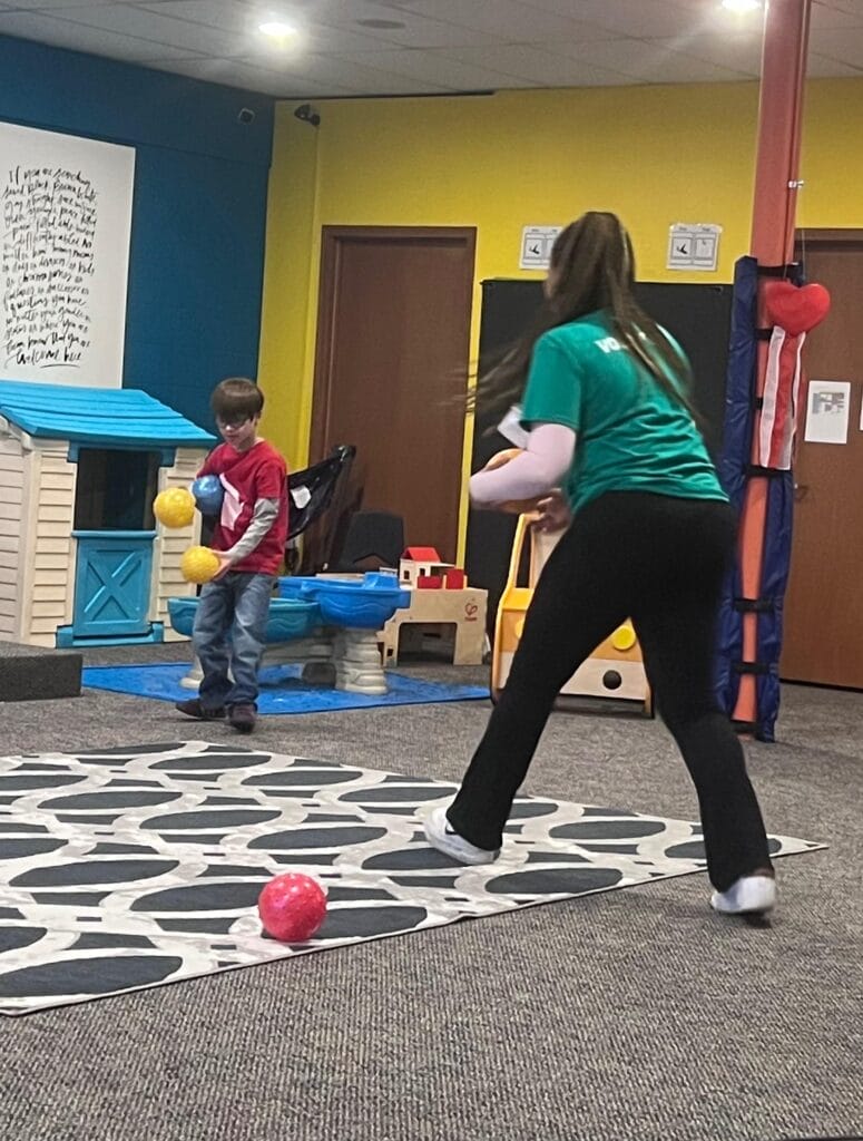 Student and tutor playing dodgeball for a brain break