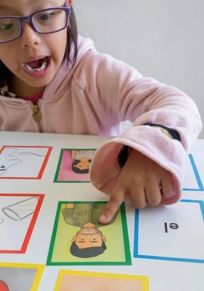 Kid in pink hoodie reading