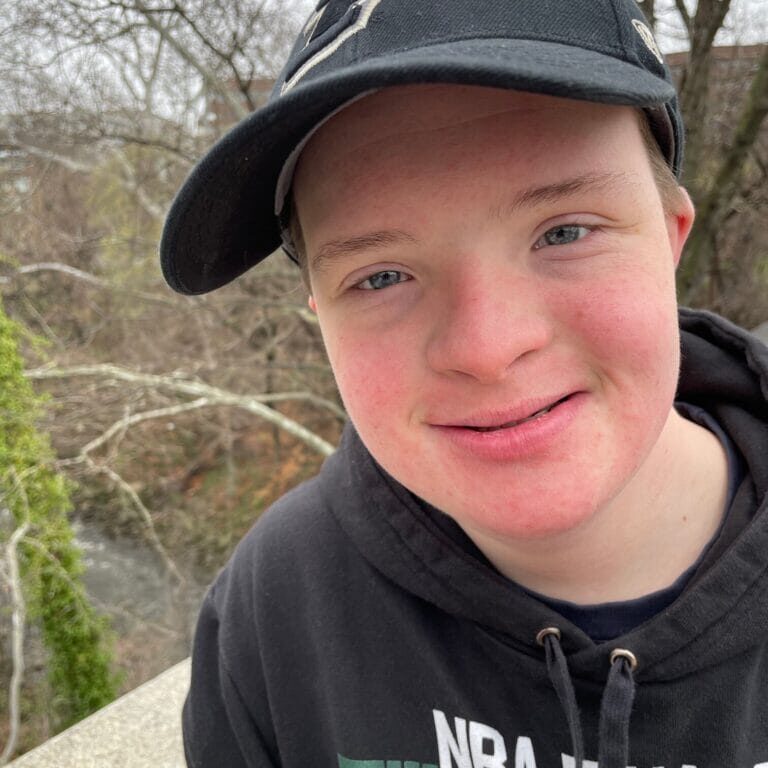 Jake is a teen with Down syndrome. Jake is seen here wearing is favorite team hat - Purdue University!