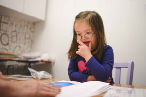 Child with Down syndrome learning to read