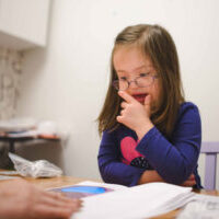 Child with Down syndrome learning to read