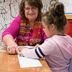 woman teaching a child