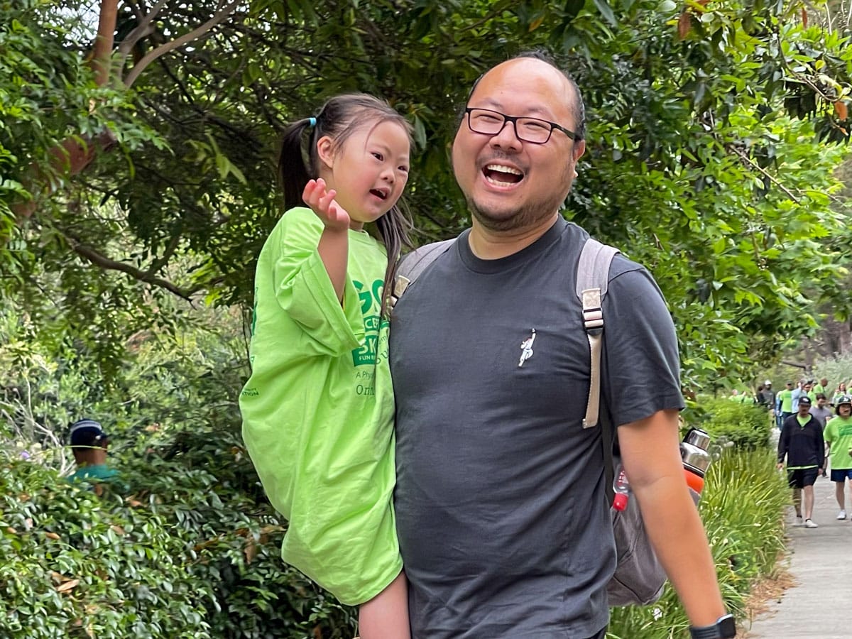 Young girl with her Dad laughing and walking