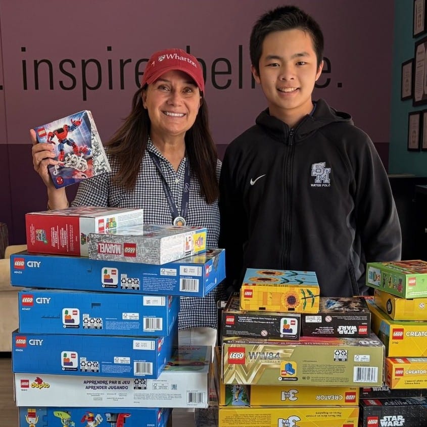 Site Manager, Suzanne Scott, with Santa Margarita Catholic High School student, Ryan Shi, and his generous donation of brand new, never opened LEGO sets.