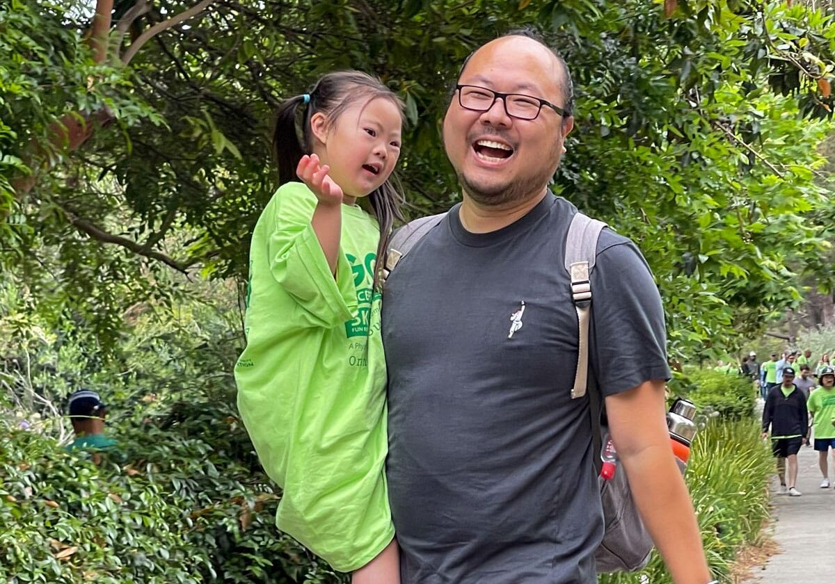 Young girl with her Dad laughing and walking