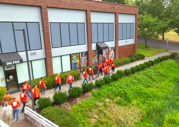 Home Depot employees approach GiGi's Playhouse Portland.