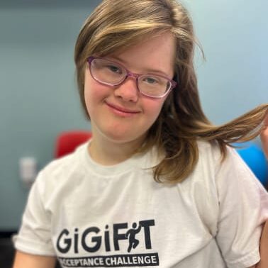 Girl in white t-shirt, holding her hair