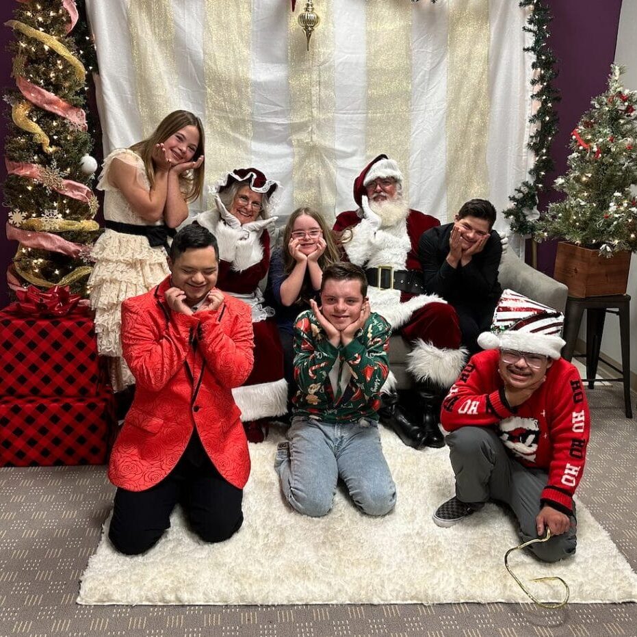 teens pose with Santa Claus at the holiday party