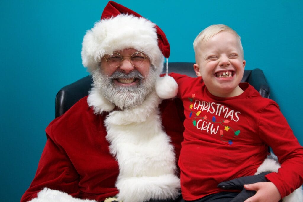 Chris dressed as Santa at the GiGi's Playhouse Twin Cities Holiday Party.