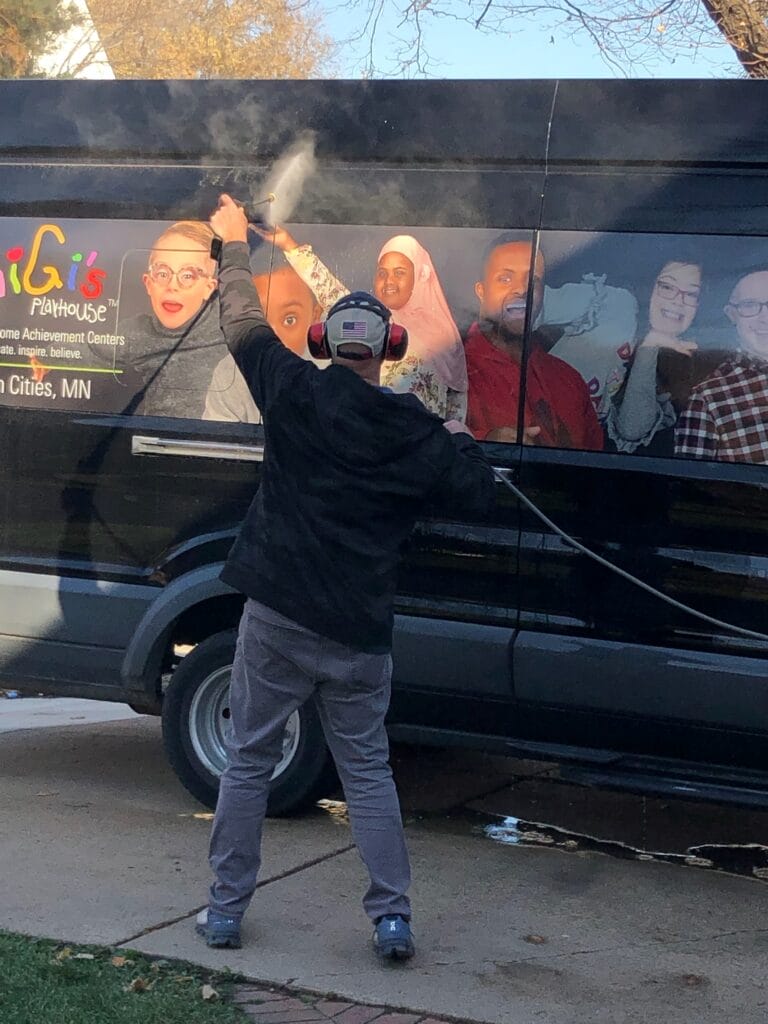 Peter washing the GIGi's On The Go Van with a powerwasher.