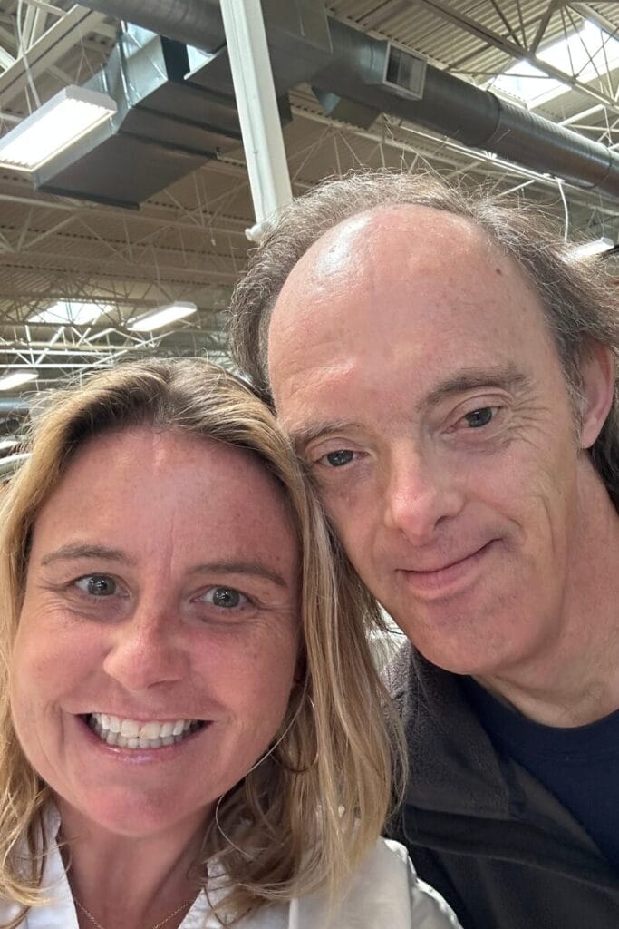 A selfie of John with a blonde women smiling,