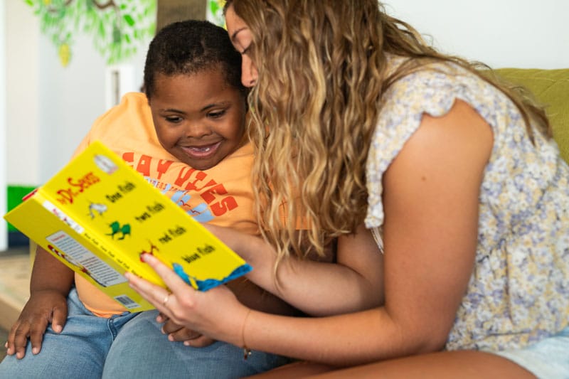 child with down syndrome reading