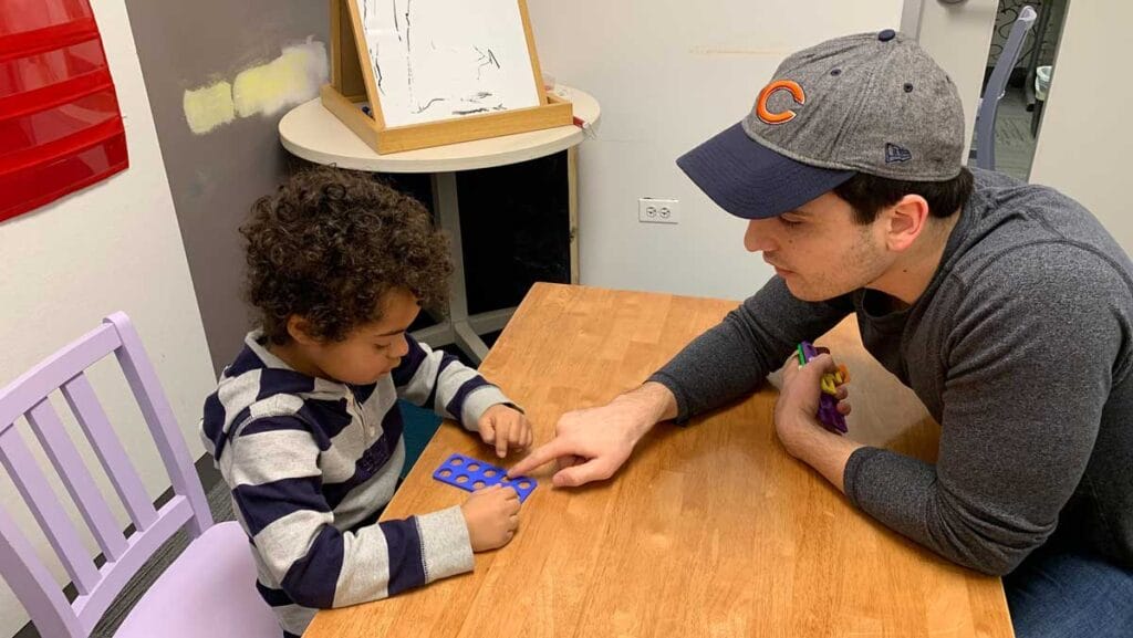 adult teaching a child to do math