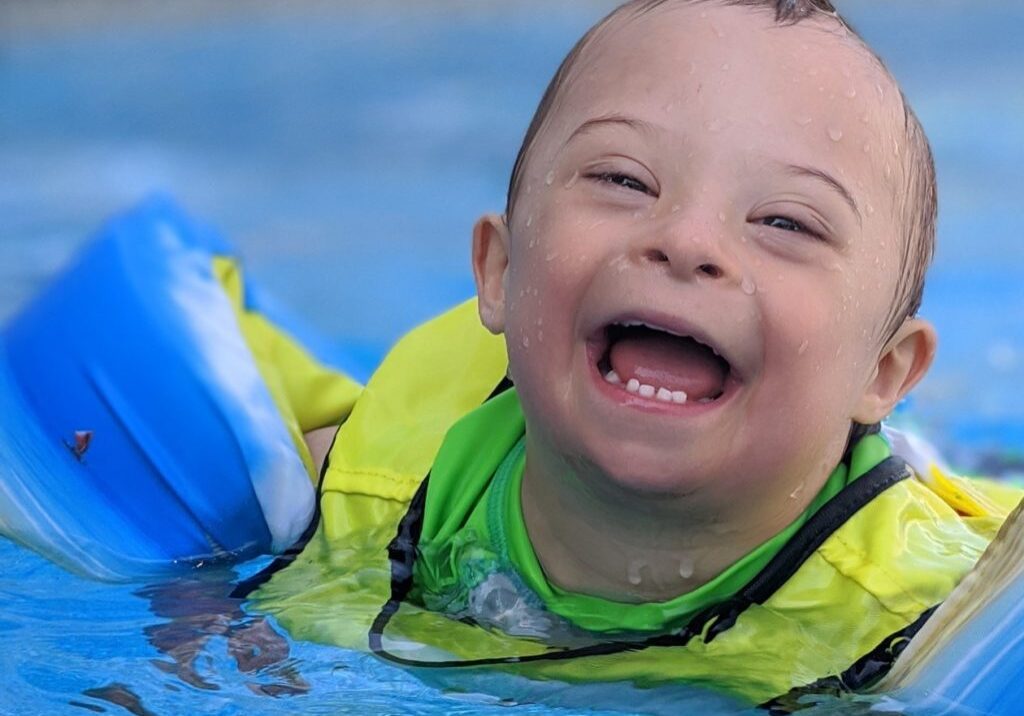 Child with Down syndrome swimming Child with Down syndrome swimming