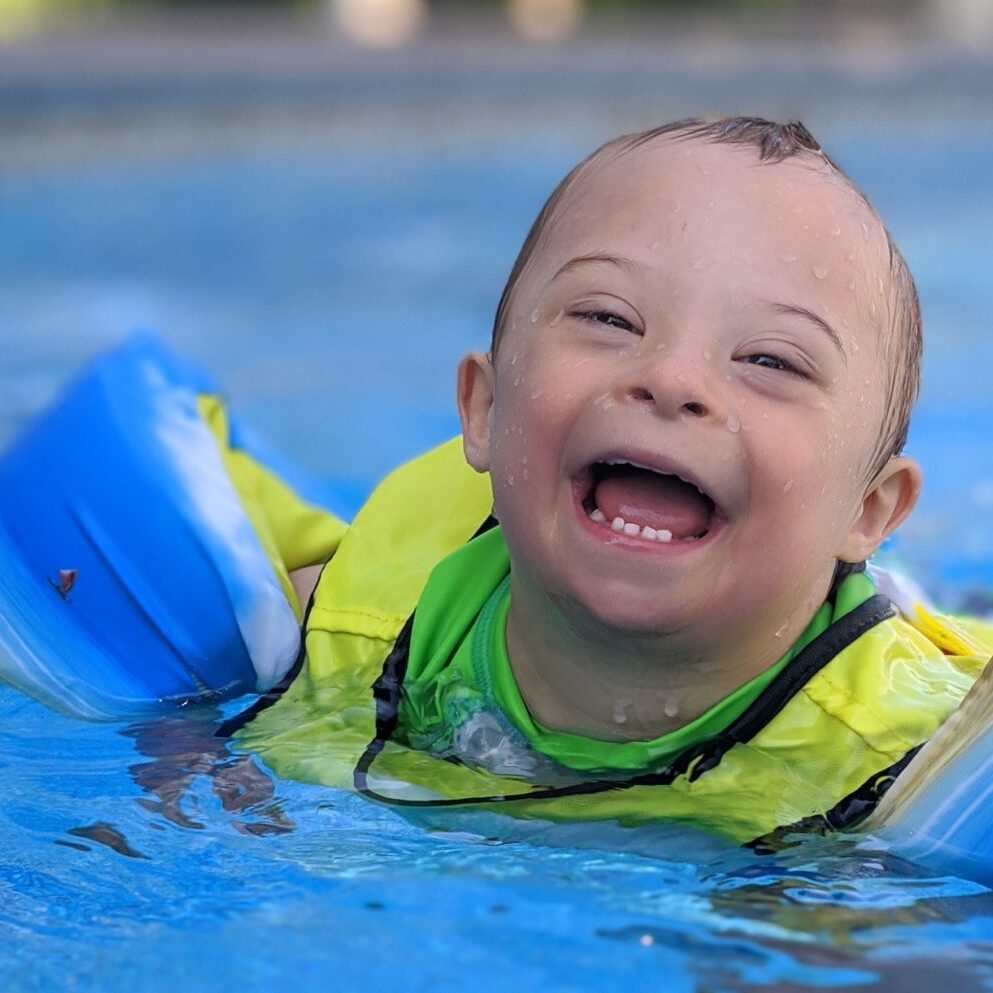 Child with Down syndrome swimming