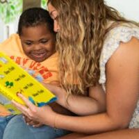 child with down syndrome reading