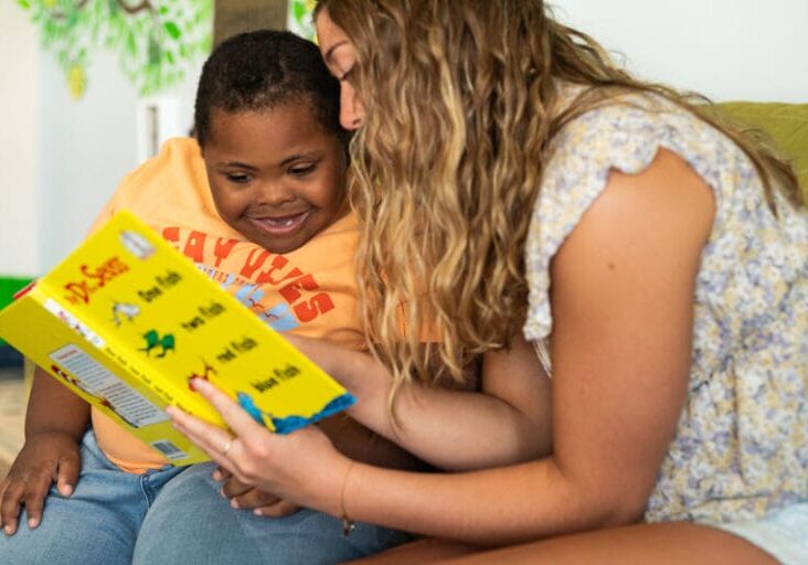 child with down syndrome reading