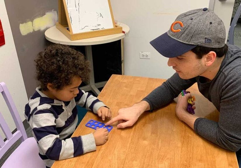 adult teaching a child to do math