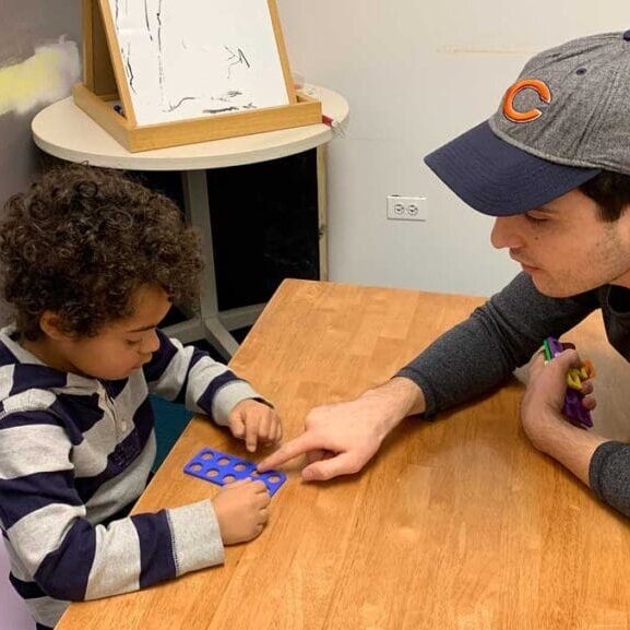 adult teaching a child to do math